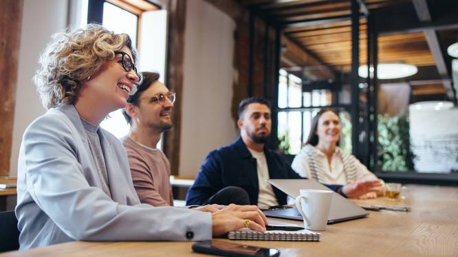 Conference meeting in an office, happy business team sits together in a boardroom Conference meeting in an office, happy business team sits together in a boardroom